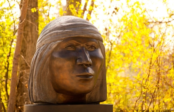 Sculpture in front of trees