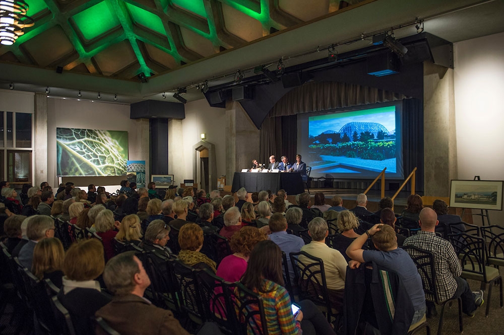 People sitting in chairs in a theater setting in Mitchell Hall
