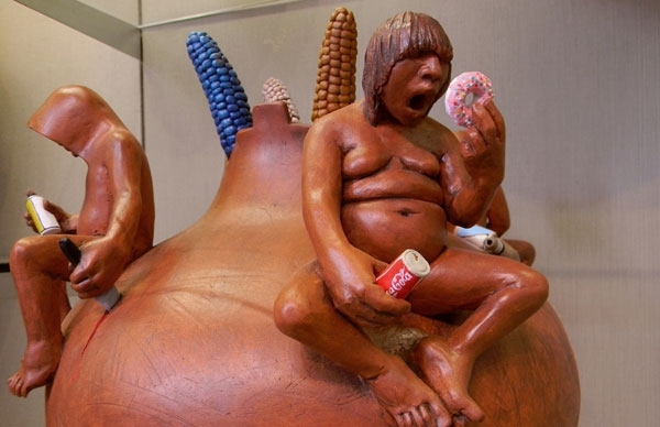 pottery depicting indigenous people eating modern junk food