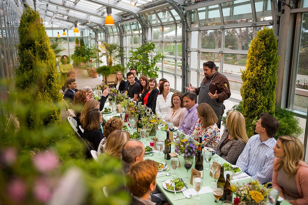 People seated at a long table in the Orangery