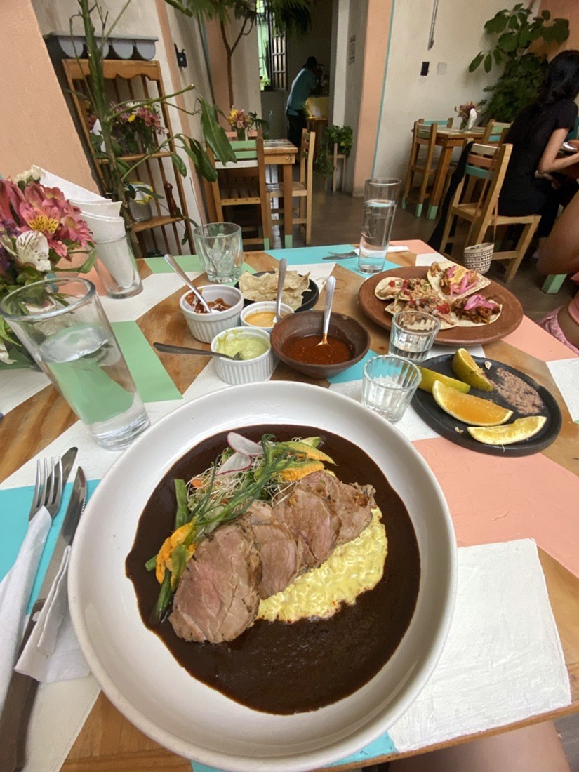 A restaurant table loaded with Mexican food