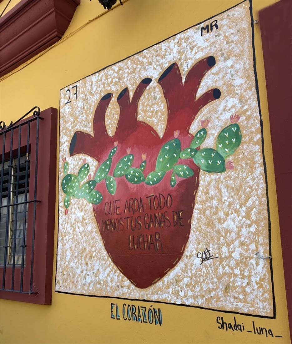 A mural of a heart with cactus around it