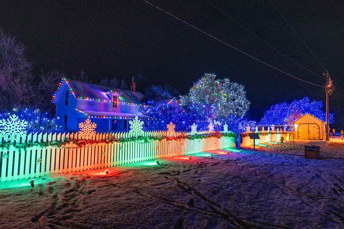 White fence lit up with red and green lights