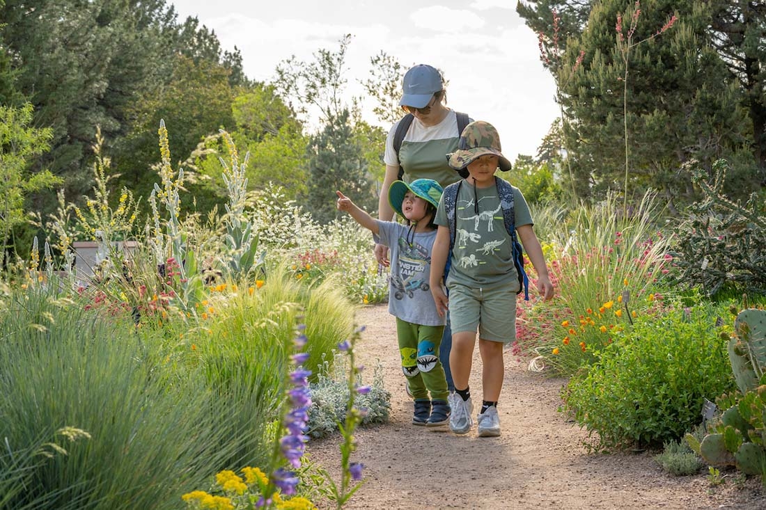 Mother with two children in botanic garden