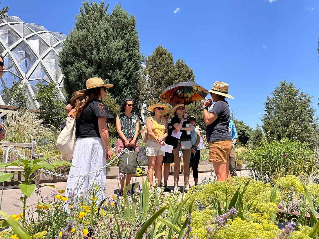 People standing on a path, looking at the speaker