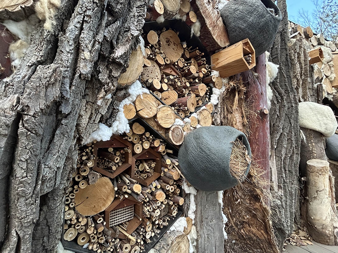 Insect hotels packed full of sticks, bamboo and hollow stems