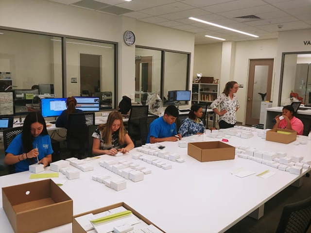 high school interns at table