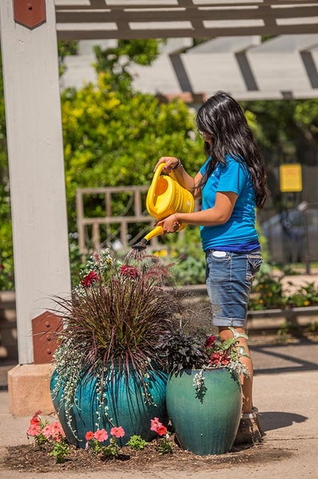 teen watering plant