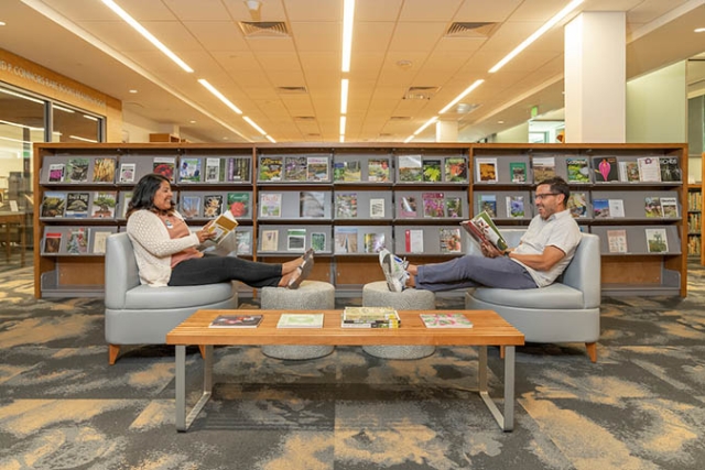 two people relaxing in library with books